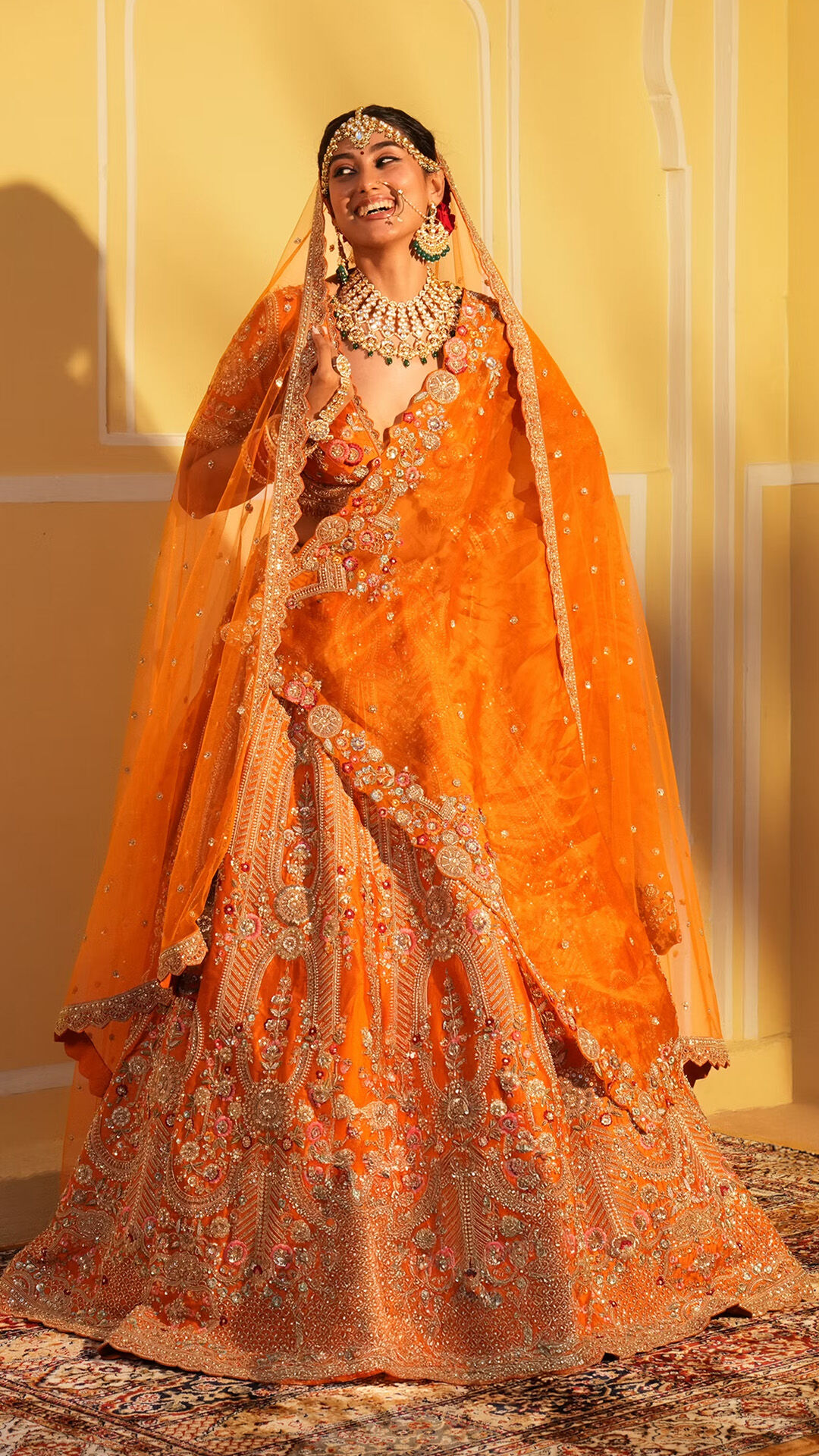 Women wearing her beautifull orange lehenga for reception 